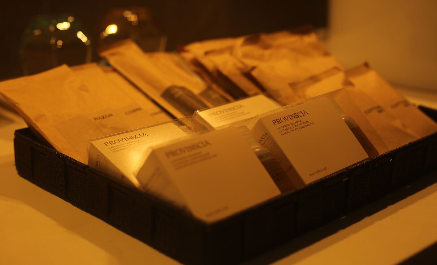 A tray of Provinscia products, including shampoo, conditioner, and body wash.