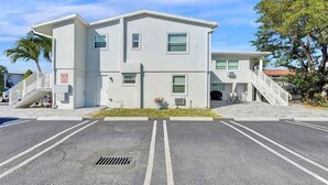 A two-story building with a parking lot in front.
