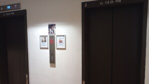An elevator with a digital display, a luggage storage sign, and a door with a number. - Cozy studio condo in wonderful Honolulu with WiFi, fitness room (Honolulu)