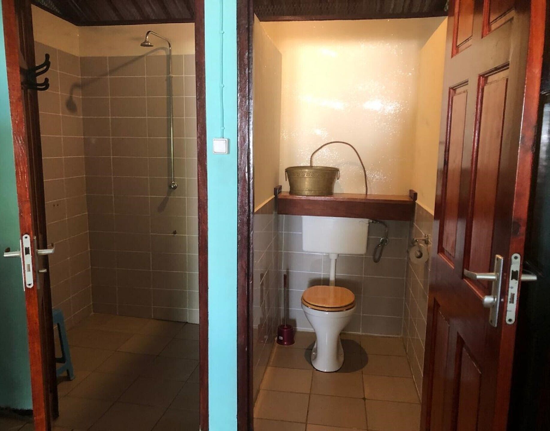 A bathroom with a shower, toilet, and a sink with a basin.