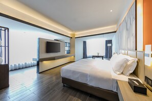 A modern hotel room with a large bed, a flat-screen TV mounted on the wall, and a wooden floor. - PESHT PREMIER HOTEL (Fuzhou)