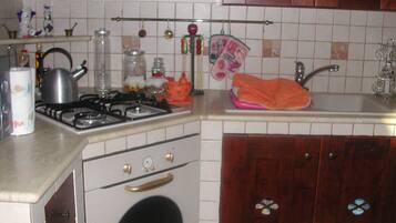 Fridge, microwave, paper towels, dining tables