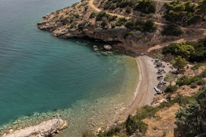 On the beach, black sand, sun loungers, beach towels