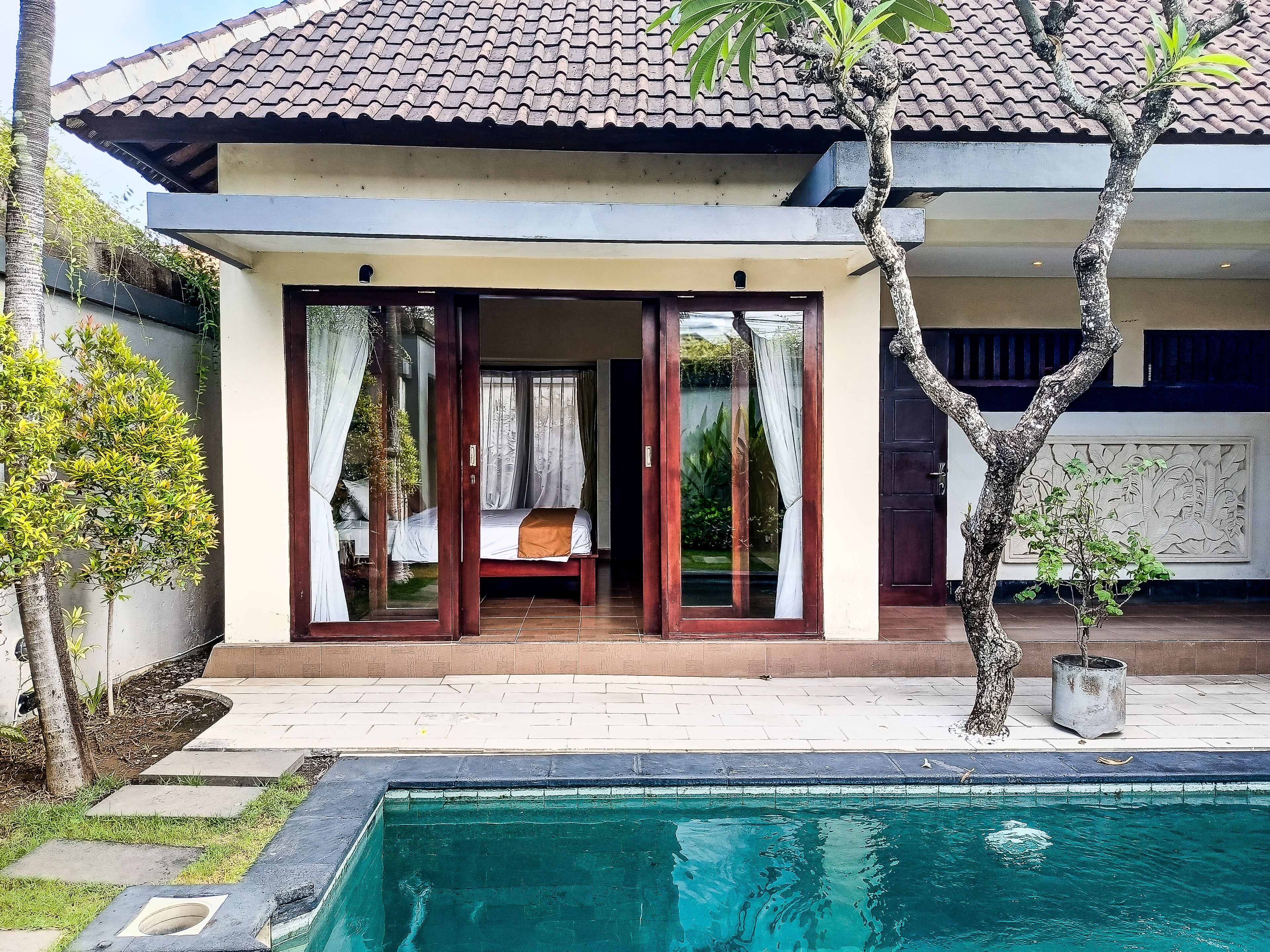 A two-story building with a swimming pool in front.