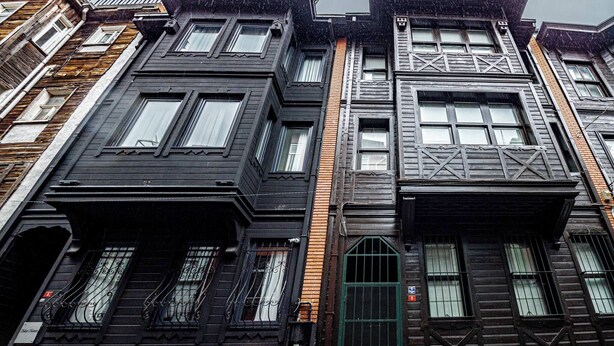 A row of multi-story buildings with distinct architectural styles, including dark wood facades and ornate window designs. - Room-deluxe Double Room 4 (Istanbul)