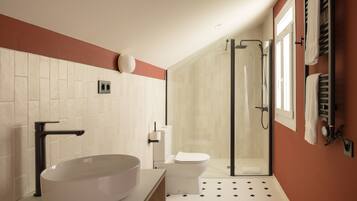 A modern bathroom with a large vessel sink, a toilet, and a glass-enclosed shower.