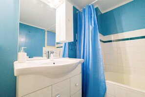 City Apartment | Bathroom | Hair dryer, towels, toilet paper