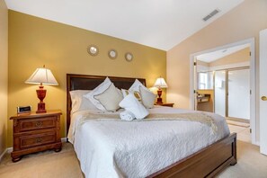 Classic hotel room with a large bed, two bedside tables, and a warm atmosphere.