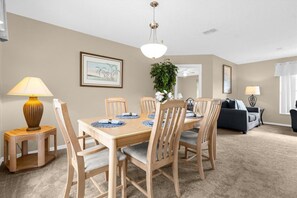 Enjoy meals in this well-appointed dining area with a table for four and comfortable seating.