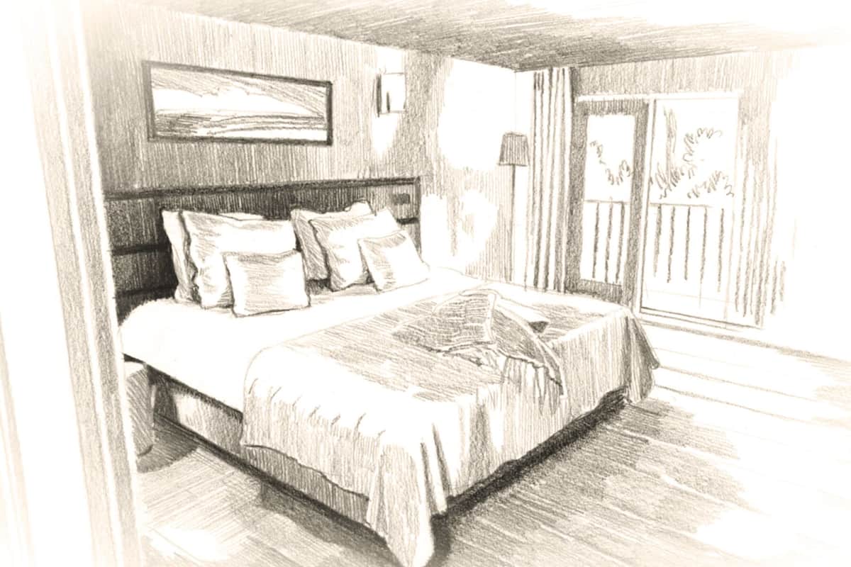 Ein Schlafzimmer mit Bett, Kissen, Nachttisch, Lampe und einem Fenster mit Vorhängen.