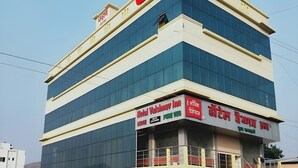 A multi-story building with signage for Hotel Vaishnav Inn and a restaurant. - Vaishnav Inn (Pune)