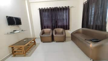 Deluxe Apartment | Living area | 28-inch flat-screen TV with cable channels