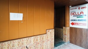 A hotel entrance with a sign indicating lodging and boarding on the 2nd floor. - Hotel Della Comfort near Ambreshwar Shiv Mandir, Ambernath (Ambernath)