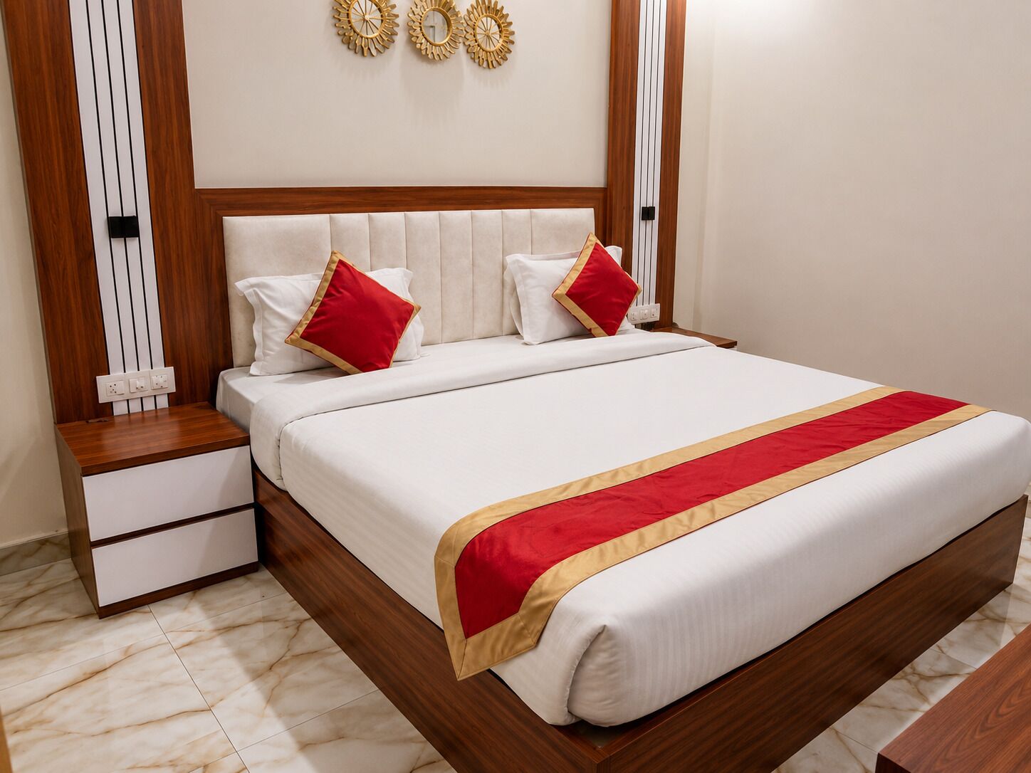 A neatly made bed with a white and red bedspread, wooden headboard, and matching nightstands.