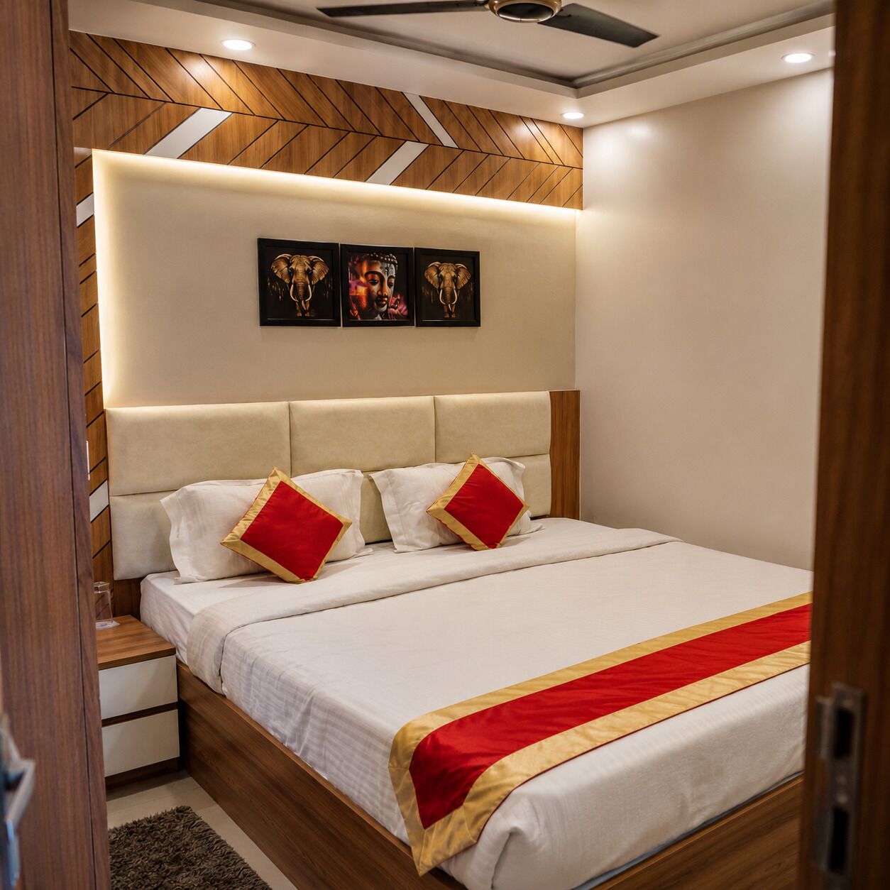 A bedroom with a bed, nightstands, a wooden headboard, and wall art.