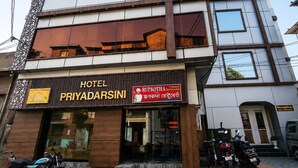 A hotel named 'PRIYADARSINI' with a signboard for 'RUPKOTHA Restaurant' and a reception area. - Hotel Priyadarsini (Bankura)