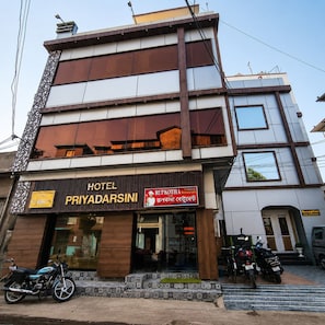 A hotel named 'PRIYADARSINI' with a signboard for 'RUPKOTHA Restaurant' and a reception area. - Hotel Priyadarsini (Bankura)