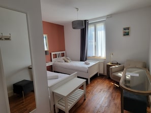 A bedroom with a bed, bedside table, chair, and a small table with a lamp. - La Sucrerie (Vexin-sur-Epte)