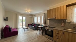 A modern apartment with a living room, dining area, and kitchen. - Michael Apartments - Private Parking (Lefkada)