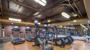 A gym with multiple treadmills, ellipticals, and exercise bikes. - Alpine Abode at Canyons Village | Ski-In/Out Condo (Park City)