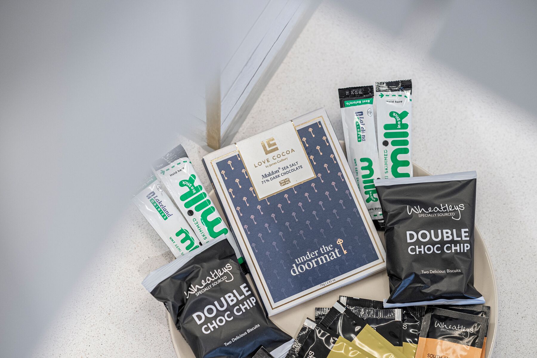 A variety of chocolate and biscuit products including brands like 'Love Cocoa' and 'Wheatleys'.