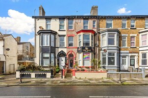 A row of terraced houses with a pub named 'The B&B' in the center.