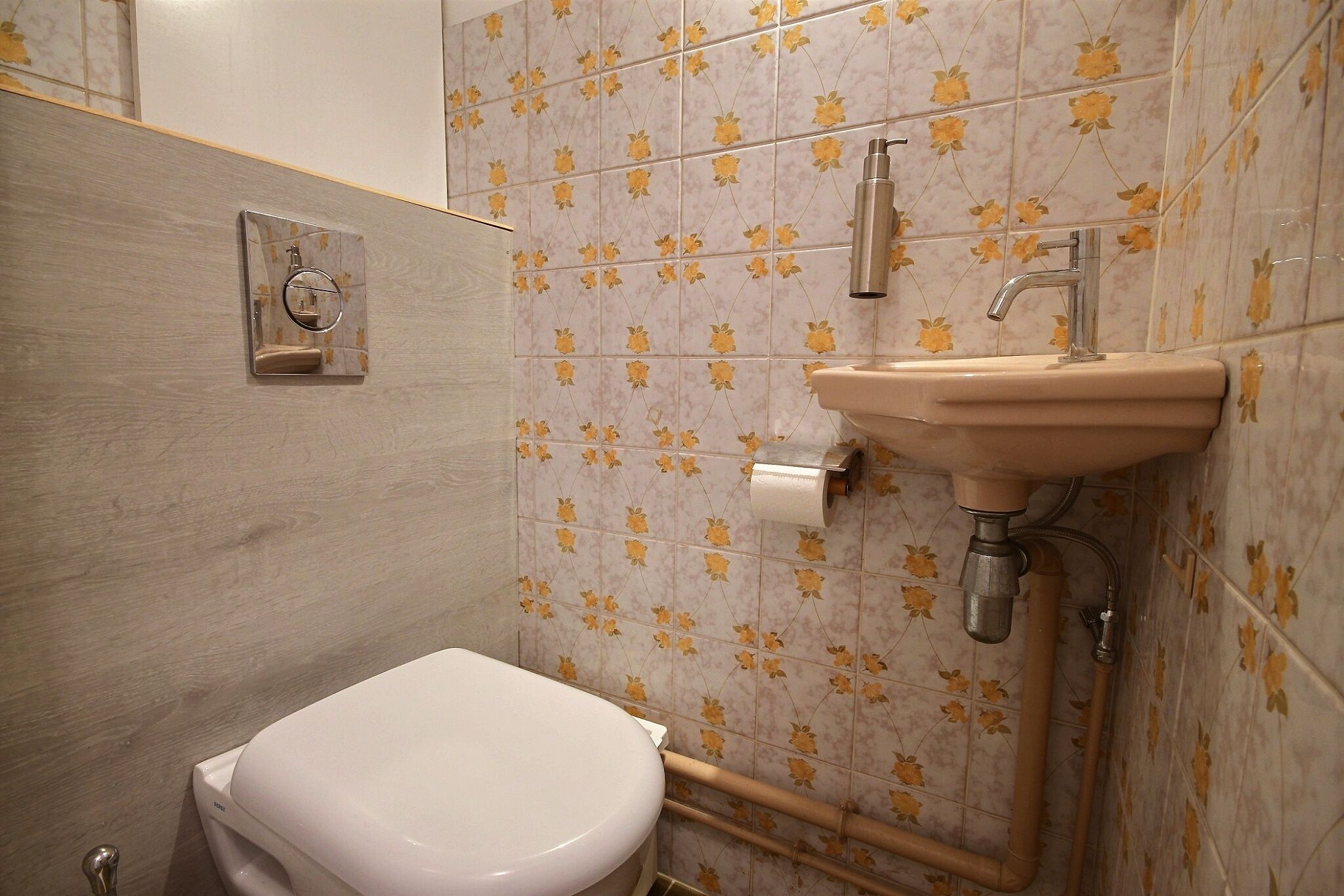 A bathroom with a toilet, sink, and shower.
