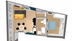 Hotellihuoneen pohjapiirros, jossa on sänky, työpöytä, tuoli, sohva ja pieni kylpyhuone.