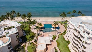 A resort with a pool, palm trees, and a beach. - Ocean Front Penthouse, Pool, Sleeps 6 people (Bucerías)