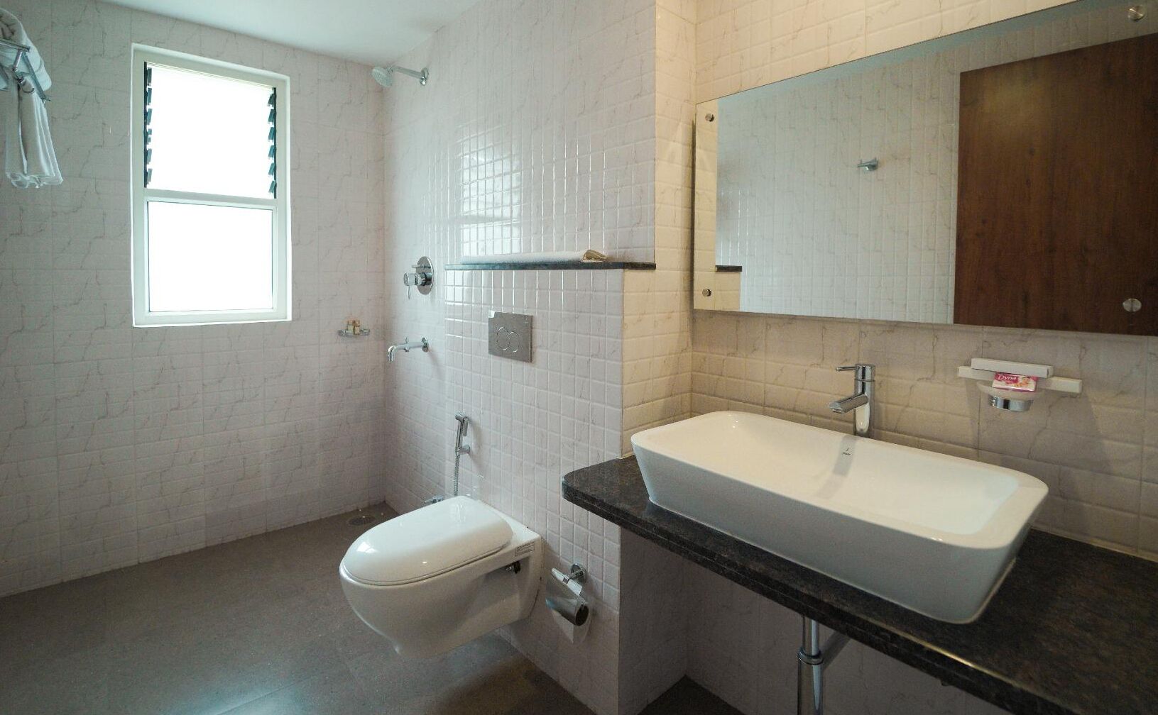 A bathroom with a toilet, sink, and shower.