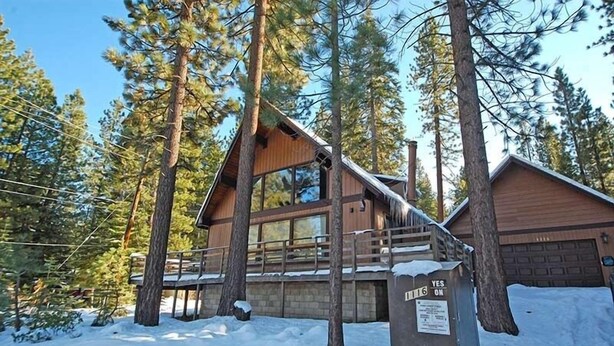 A cabin with a wooden exterior, large windows, and a covered deck. - 1116 Golden Bear 3 Bedroom Cabin by RedAwning (South Lake Tahoe)