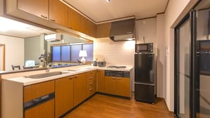 A modern kitchen with wooden cabinets, a stainless steel refrigerator, a microwave, and a dishwasher. - It' ta de JPN - Self Check-In Only (Osaka)