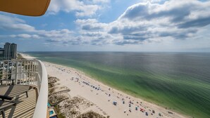 A beach with clear waters, a sandy shore, and a view of the ocean.