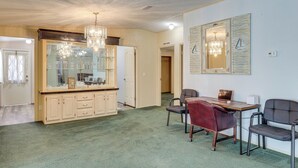 A spacious room with a dining area, a large mirror, and a chandelier. - Peaceful Mcalpin Home on 5 Acres w/ Private Deck! (Live Oak)