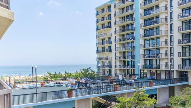 A multi-story hotel with balconies, a pool area, and a view of the beach. - Oceanfront Building With Great Ocean and Bay Views (Ocean City)