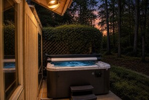 A hot tub in a backyard with a wooden deck and a lattice fence. - 11 Salem Road - New to Rental Market and Great Spring and Summer Pricing! (Hilton Head Island)