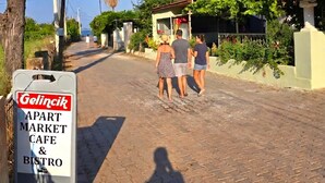 A cobblestone street with a sign for 'Gelicik Apart Market Cafe & Bistro.' - Gelincik Apart (Marmaris)