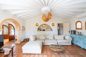 A spacious living area with a large sofa, a coffee table, and a kitchen in the background. - CostaBlancaDreams - Casa Julo in Calpe (Calpe)