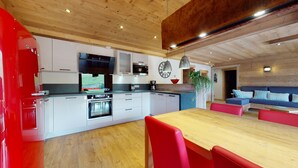 Una cucina moderna con mobili bianchi, forno integrato e un'isola spaziosa con posti a sedere.