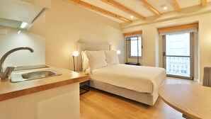 A bedroom with a bed, a sink, and a balcony. - BOULEVARD Boutique Studios   (Lisbon)