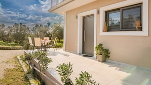 A modern house with a balcony, outdoor seating, and a view of the sky. - !!New!! Andriana’s apartment
A fully equipped 2-BR apt in the countryside
 (Zakynthos)