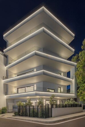 A multi-story hotel with a modern design, featuring balconies and a well-lit facade. - No Stars (Ioannina)