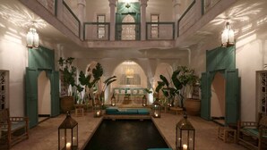 A luxurious spa area with a central pool, seating areas, and decorative lanterns. - Riad DAR DAR (Marrakech)