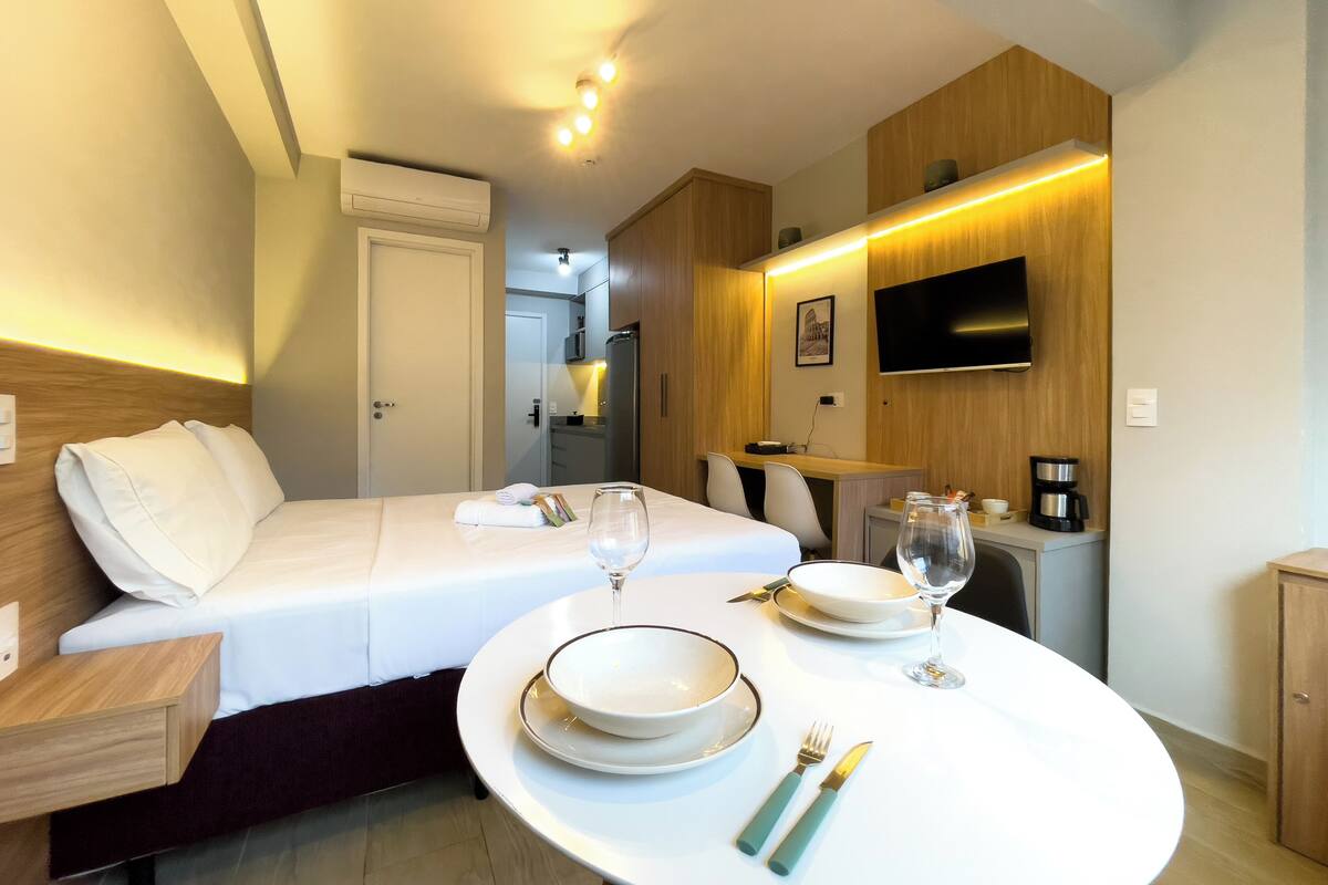 Studio | Premium bedding, desk, laptop workspace, blackout drapes