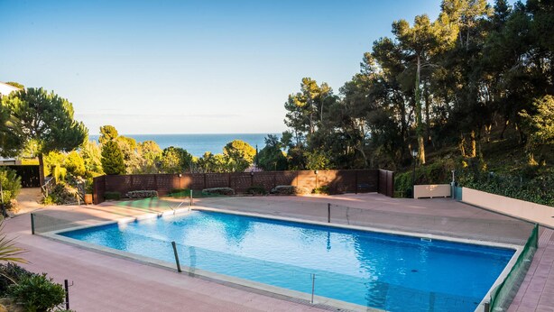 A rectangular swimming pool with a clear blue water surface, surrounded by a tiled deck. - AE-1 Charming Apartment in El Golfet (Calella de Palafrugell)