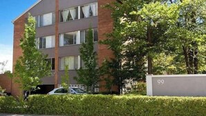 A multi-story building with a brick facade and large windows. - Quiet 2BR Apartment with Garden views in Griffith (Griffith)