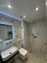 Hair dryer, towels, shampoo, toilet paper