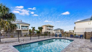 A swimming pool with a clear view of the sky and surrounding buildings.