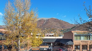 A building with a brick facade and a glass storefront. - North Of Nell, Unit 2k (Aspen)
