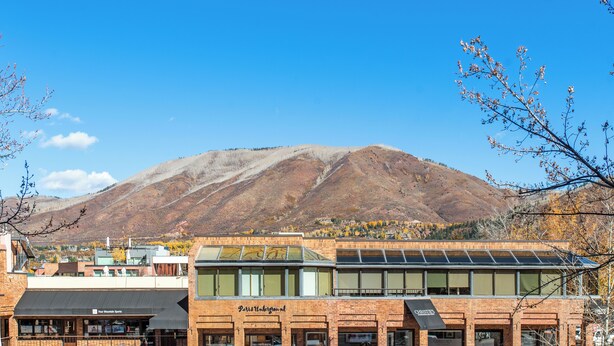 A building with a sign reading "Paris Underground" and a mountain in the background. - North Of Nell, Unit 2m (Aspen)